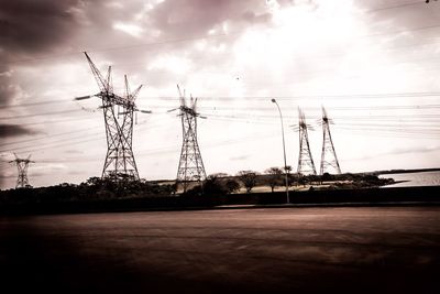 Electricity pylon on landscape against sky