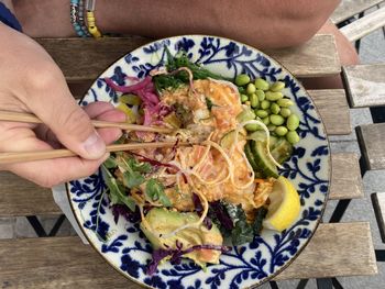 Cropped hand of woman holding food