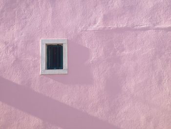 Window on pink wall