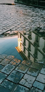 Reflection of building in puddle on lake