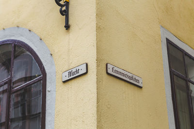 Close-up of information sign on wall