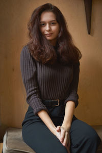 Portrait of smiling woman sitting at home