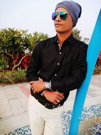 Young man wearing sunglasses standing outdoors