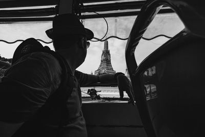 Side view of man siting in bus