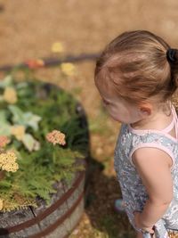 High angle view of girl looking at plants