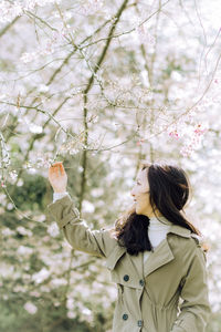 Rear view of woman holding flowers