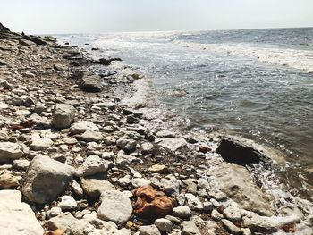 Rocks on beach against sky