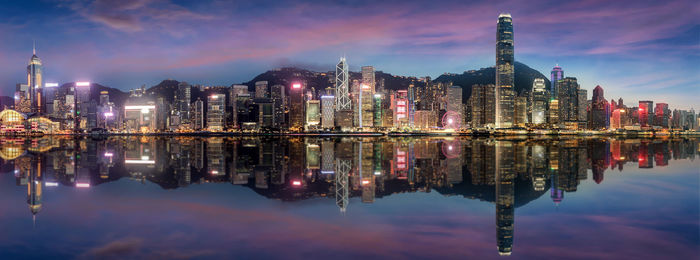 Reflection of illuminated buildings in lake at night