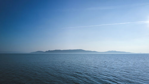 Scenic view of sea against blue sky