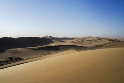 Scenic view of desert against clear sky