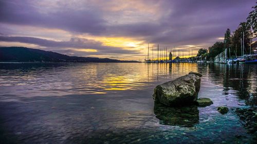 Scenic view of lake against dramatic sky