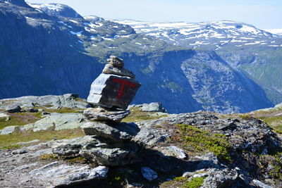 Rear view of people on snowcapped mountain against sky