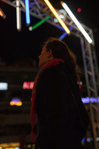 Mid adult woman looking at illuminated stage