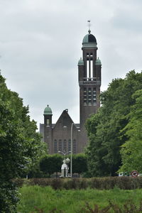 Church by building against sky