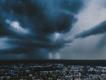 Cityscape against cloudy sky