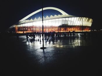 Silhouette built structure against clear sky at night