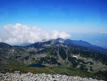 Scenic view of mountains against blue sky