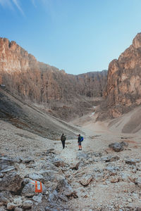 Rear view of man walking on mountain
