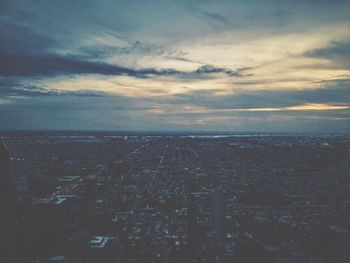 Scenic view of sea against cloudy sky at sunset