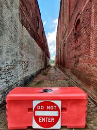 Red information sign on wall