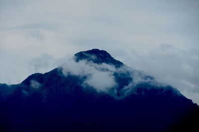 Low angle view of volcanic mountain against sky