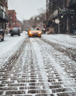 Cars on street during snowfall