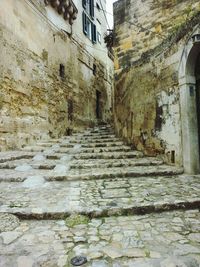 Walkway amidst stone wall