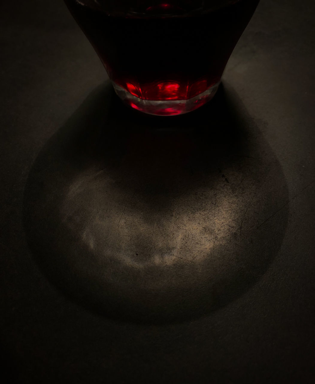 HIGH ANGLE VIEW OF RED WINEGLASS ON TABLE