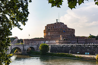 Arch bridge over river against sky