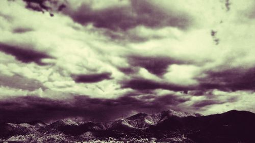 Scenic view of mountains against cloudy sky