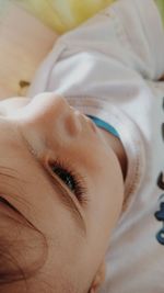 Close-up portrait of woman lying down on bed