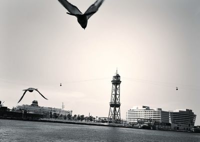 Crane against sky in city