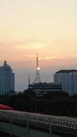 Silhouette of buildings against sky at dusk