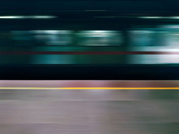 Blurred motion of train at railroad station