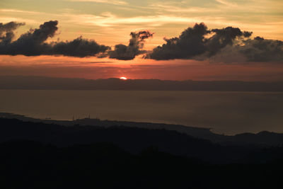 Scenic view of silhouette mountains against sky during sunset