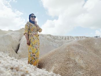 Woman standing on land against sky