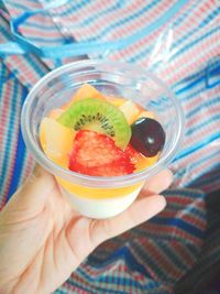 Midsection of person holding fruit