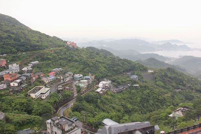 High angle view of houses and trees against sky