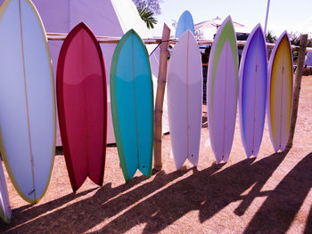 Multi colored surfboards in a row on beach