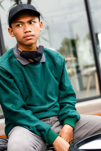 Portrait of young man sitting outdoors