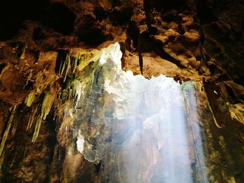 Low angle view of cave against sky