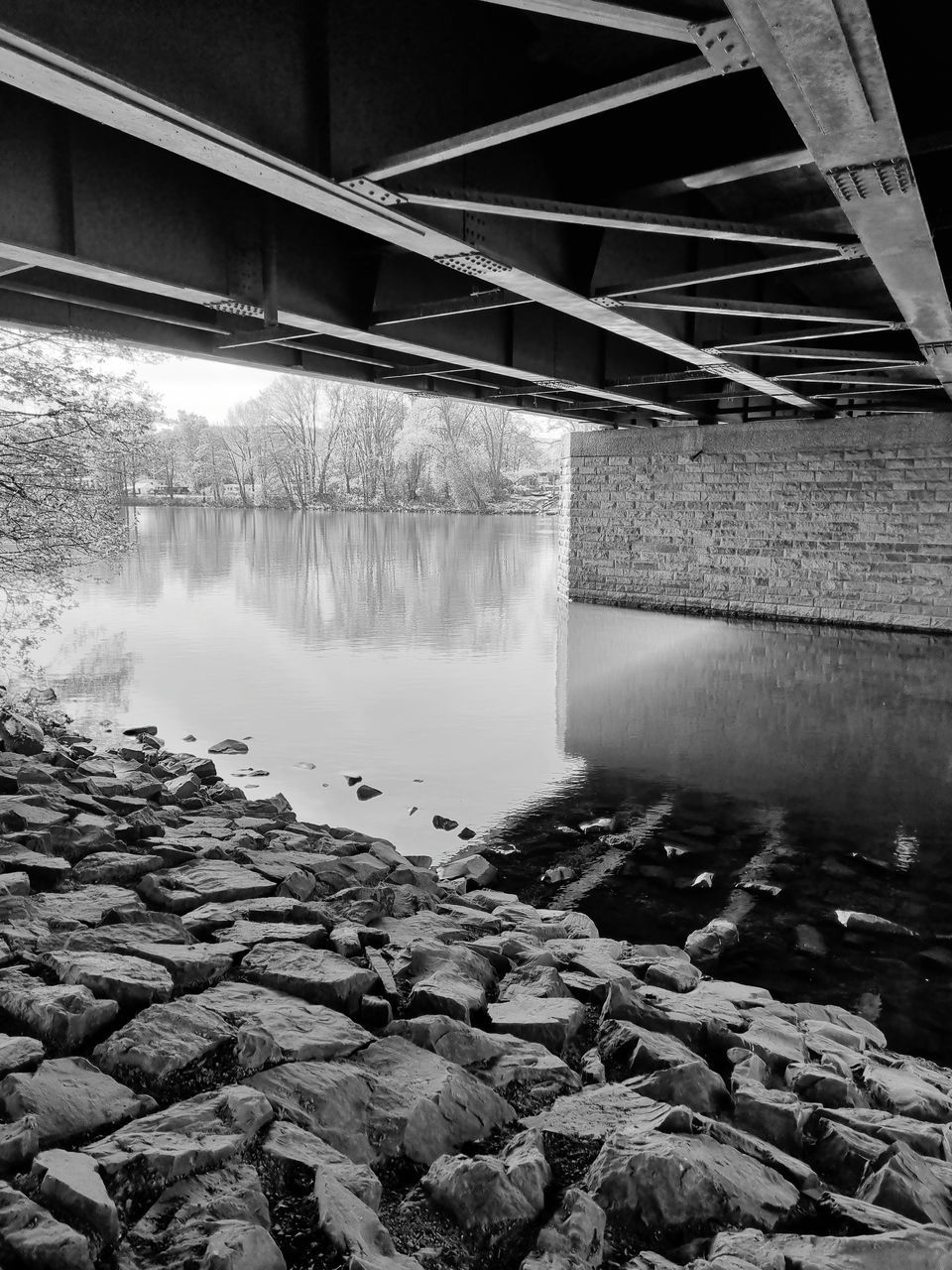 black and white, monochrome, water, monochrome photography, architecture, built structure, black, darkness, reflection, white, no people, bridge, nature, river, day, outdoors, rock