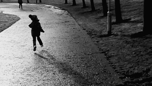 Woman walking on road