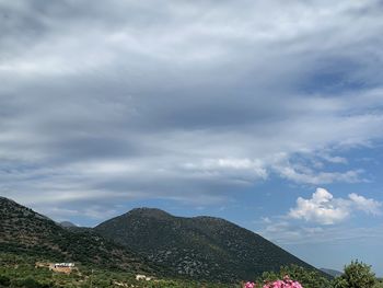 Scenic view of mountain and buildings against sky