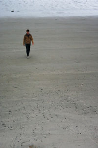 Full length of man walking on beach