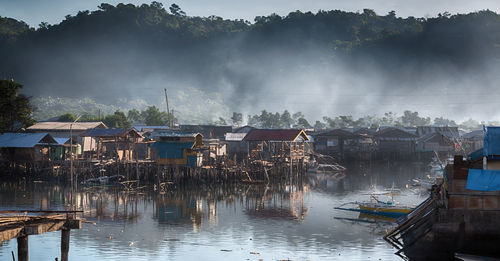 Panoramic view of lake and buildings in village