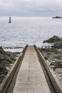 Scenic view of rescue boat path driving to the sea against sky