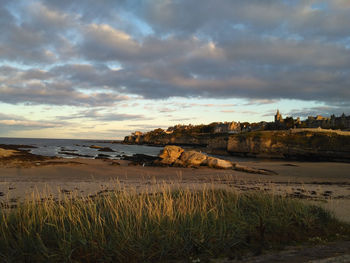 View of beach against cloudy sky