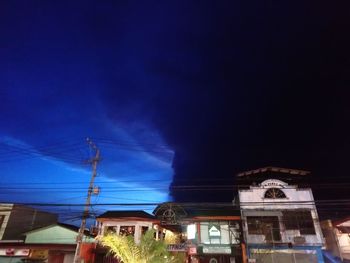 Low angle view of illuminated building against sky at night