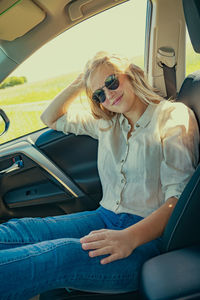 Portrait of woman sitting in car